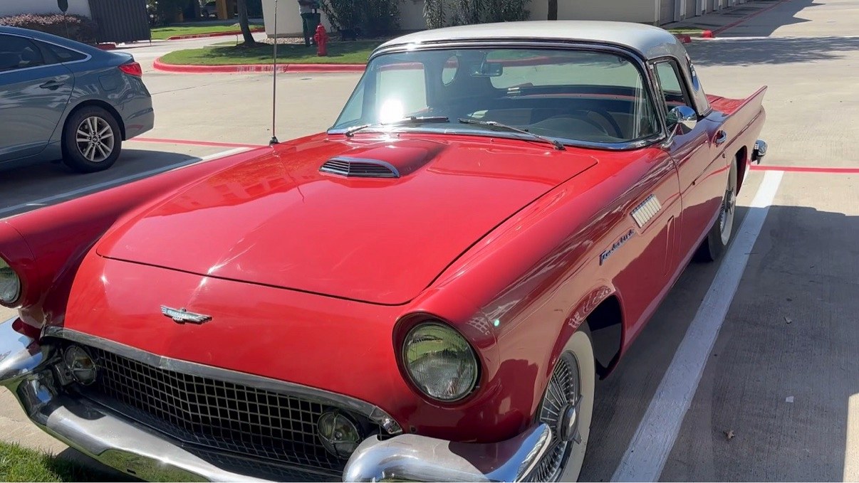The collection's red 1957 Ford Thunderbird with white porthole hardtop, front three-quarter view